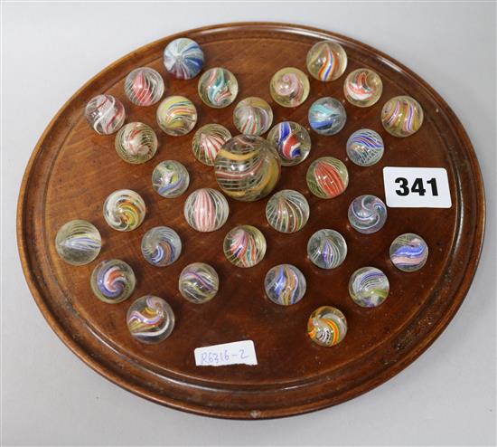 A 19th century solitaire board with latticino marbles and other antique marbles